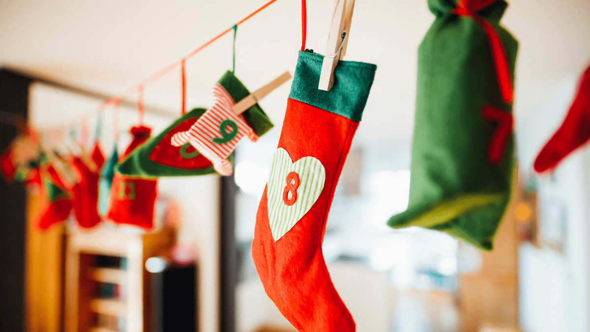 https://www.pexels.com/photo/red-and-green-christmas-stocking-hanging-inside-room-1679769/